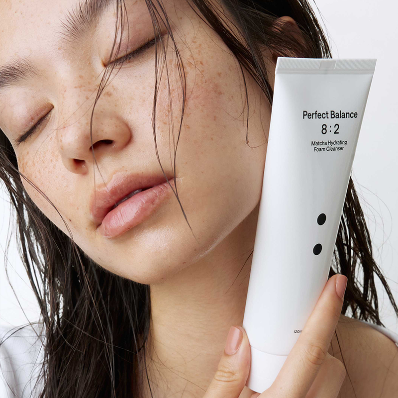 B : Lab Matcha Hydrating Foam Cleanser in a white tube with green accents, showing the product ready for use.
