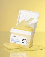 Numbuzin No.5 Vitamin Niacinamide Concentrated Toner Pads laid out on a white surface, showing their round shape and packaging.