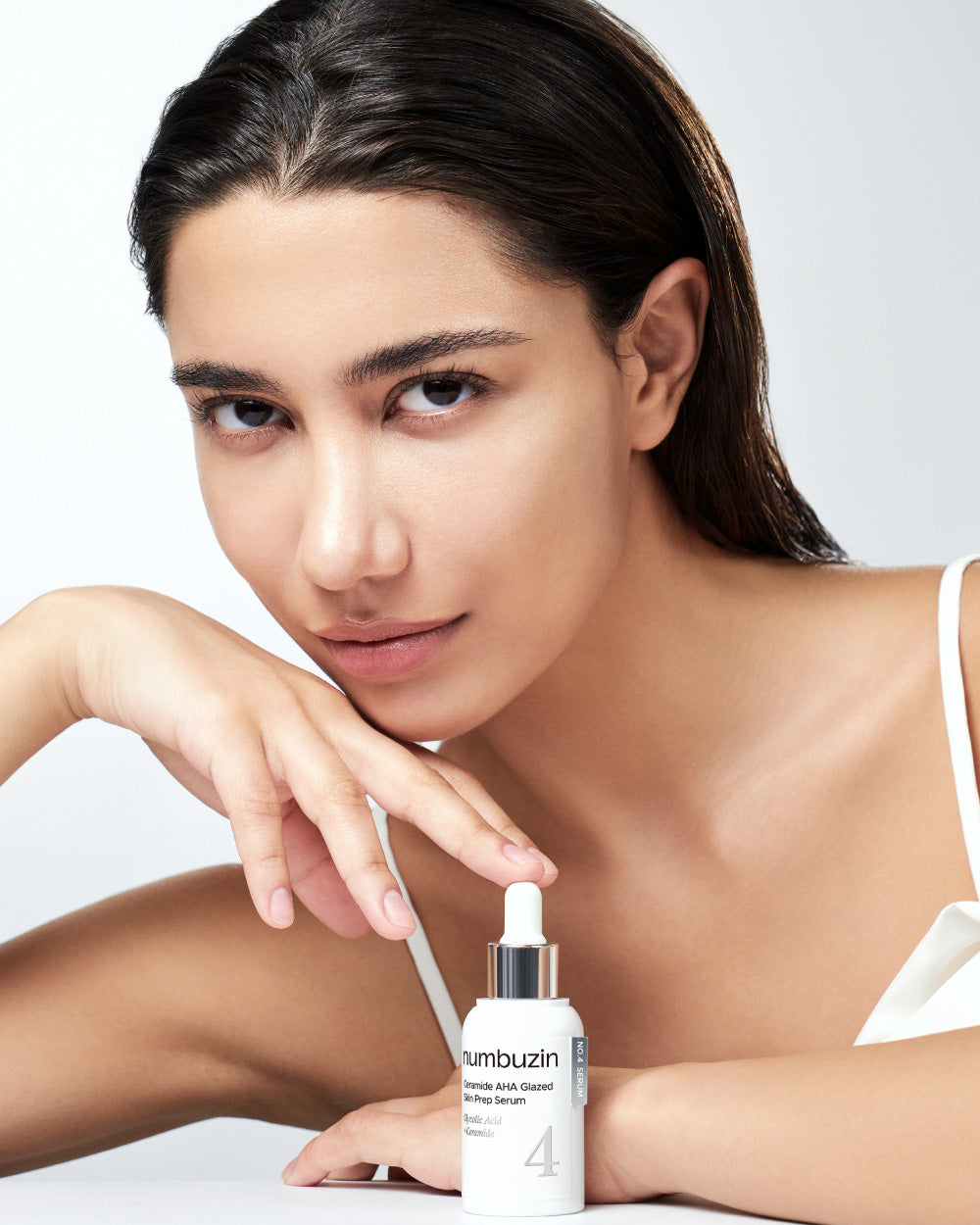 Numbuzin No.4 Ceramide AHA Glazed Skin Prep Serum in a clear bottle with dropper for smooth, glowing skin enhancement.