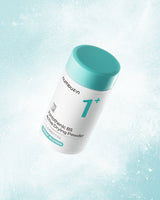 White container with teal lid labeled 'numi' on a light blue gradient background