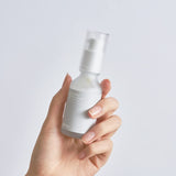 Celimax Dual Barrier Skin Boosting Serum in a clear glass bottle with a white pump dispenser, showing the product label.