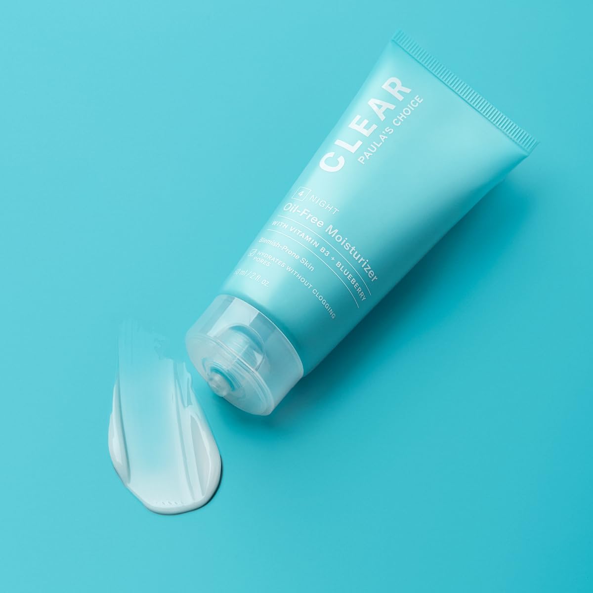 SKINZA Paula's Choice CLEAR Oil-Free Night Cream jar with white lid and label, smooth cream visible inside.