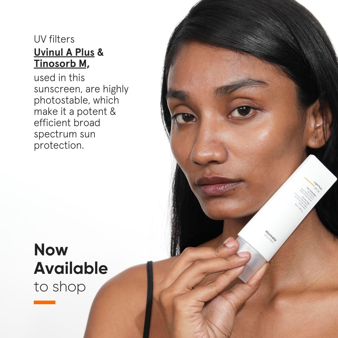SKINZA minimalist SPF 50 light fluid sunscreen bottle with a sleek white design and pump dispenser, suitable for daily use