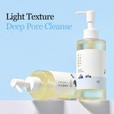 ROUND LAB 1025 Dokdo Cleansing Oil in a 200 ml bottle, featuring a clear face essence with a sleek design and label.