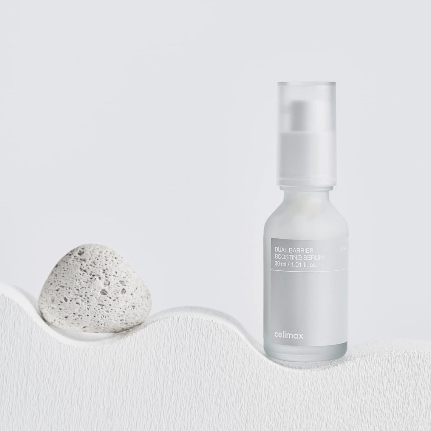Celimax Dual Barrier Skin Boosting Serum in a clear glass bottle, with dropper applicator and white label.