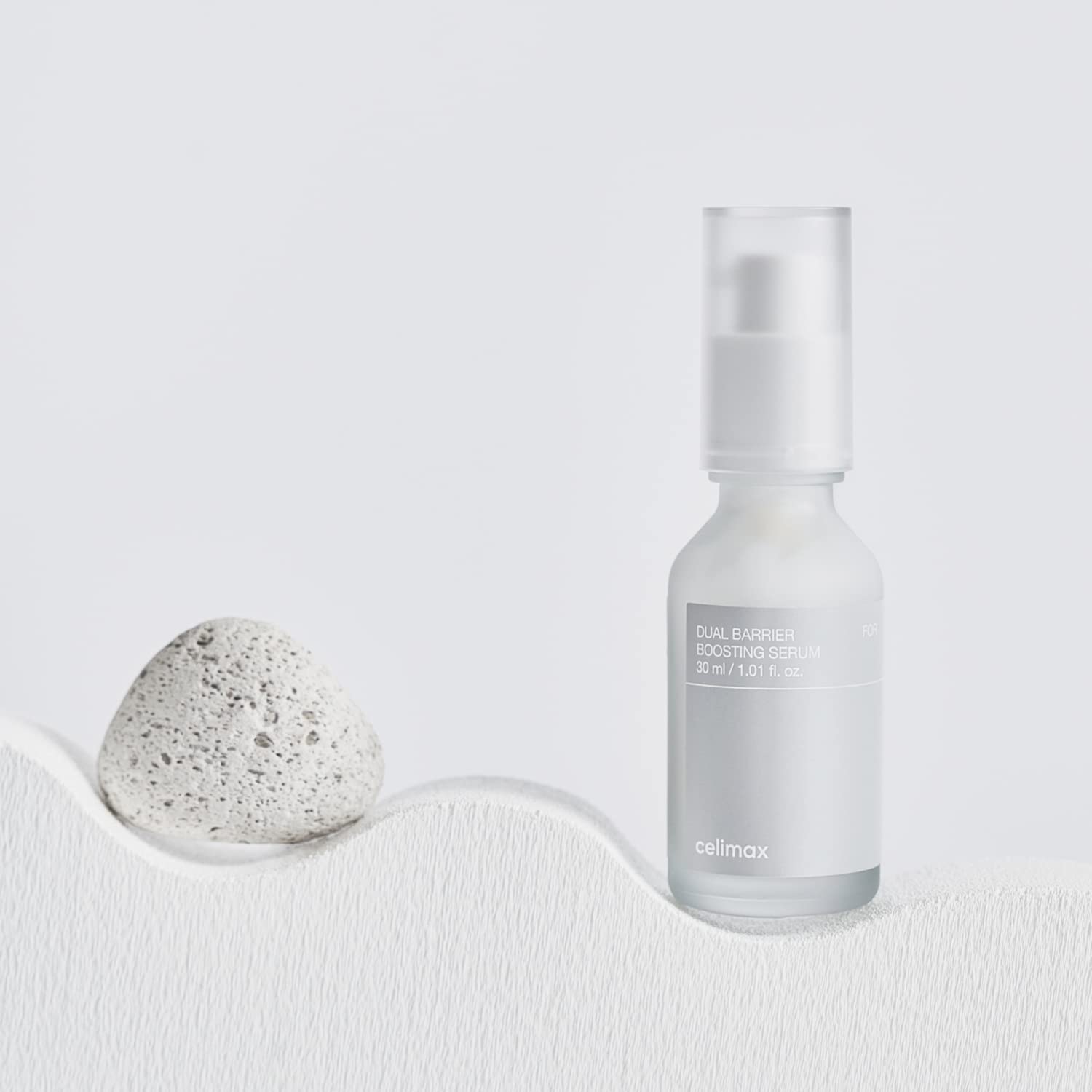 Celimax Dual Barrier Skin Boosting Serum in a clear glass bottle, with dropper applicator and white label.