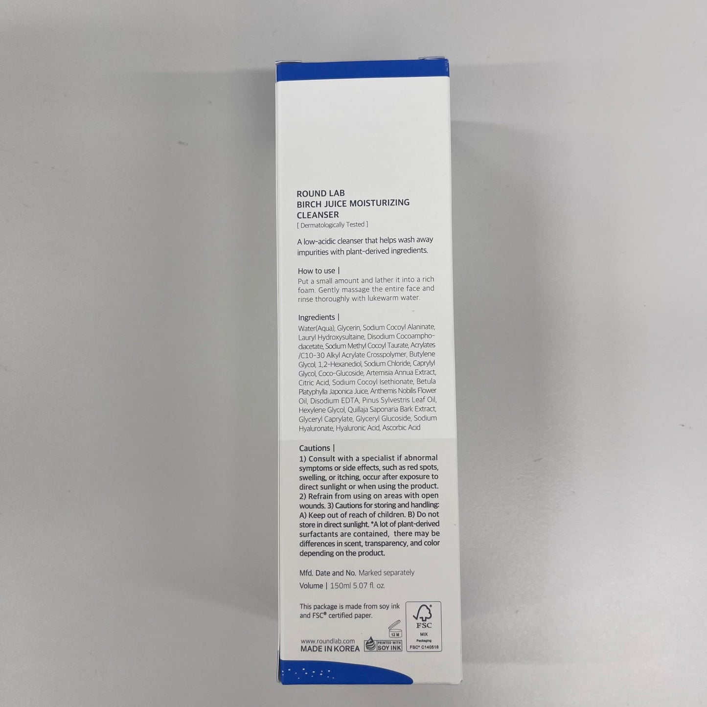 ROUND LAB Birch Juice Moisturizing Cleanser in a white tube with blue accents, displayed on a flat surface.