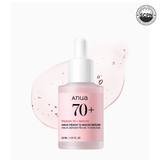 Anua US Peach 70% Niacinamide serum ampoule with a clear glass bottle and dropper, surrounded by fresh peach slices.