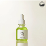 Beauty of Joseon Calming Serum with green tea and panthenol for soothing face care, shown in a clear bottle with a pump dispenser.